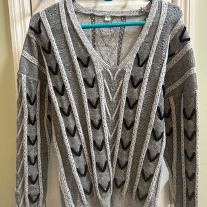 Women's size Large grey and black sweater top, it is in like new condition,